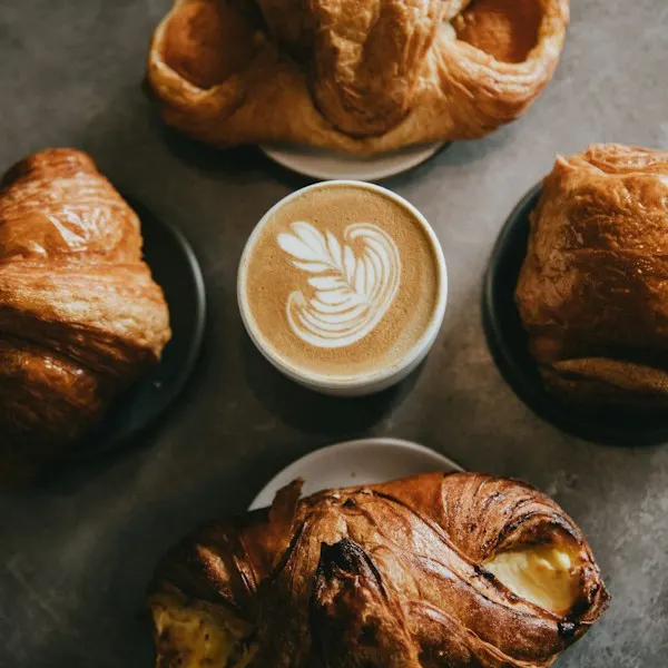 Pastries around a cup of coffee