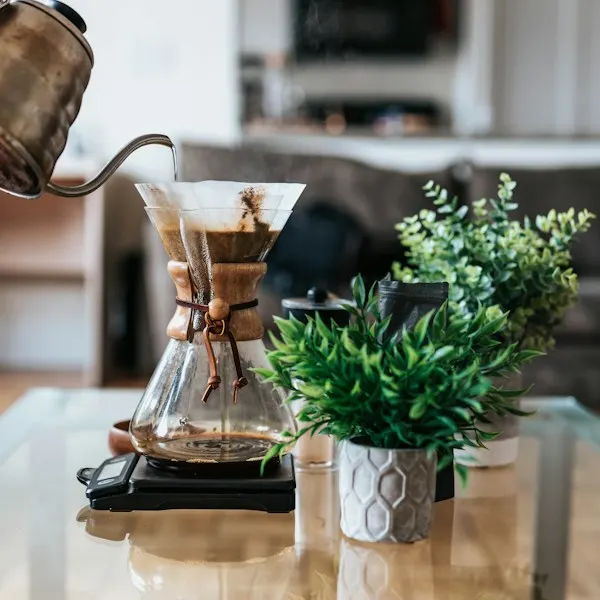 Coffee being poured from a glass brewer