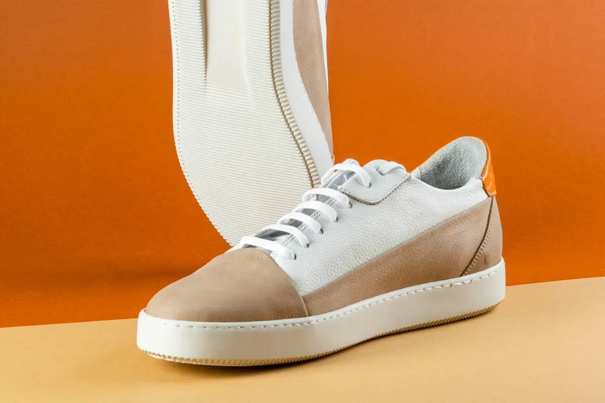 The sneaker from the side, with its sole and laces in focus