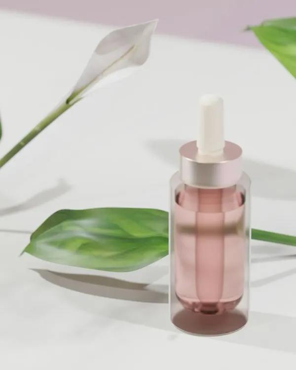 A pink dropper bottle beside a green leaf