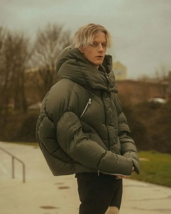 A woman in a long dark parka standing in snow
