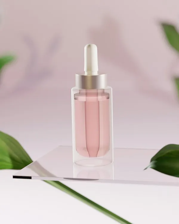 A pink serum bottle on a pale table