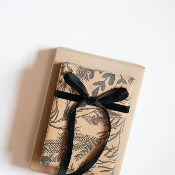 A book wrapped in patterned paper and tied with a black ribbon